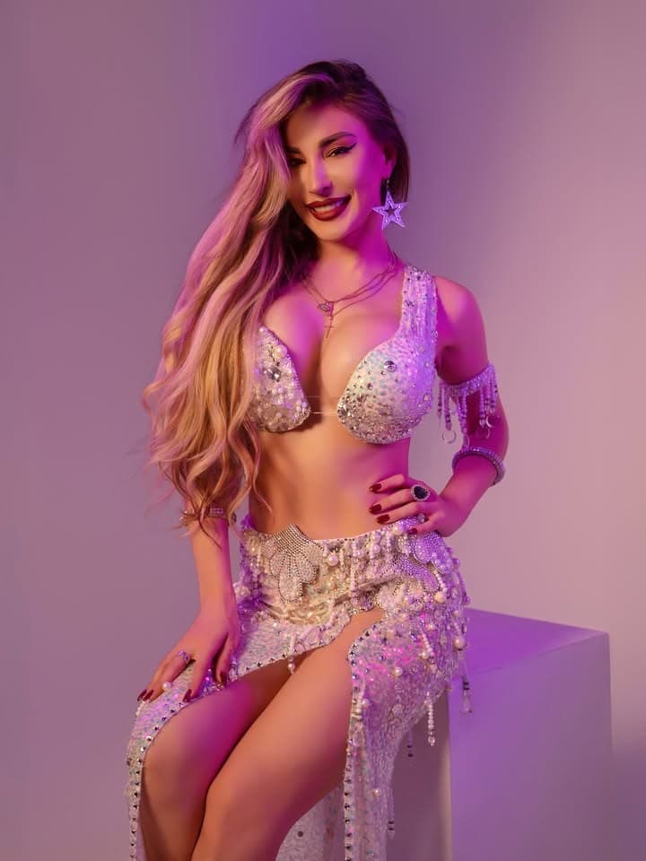 Allavats in a silver crystal costume under pink and purple light